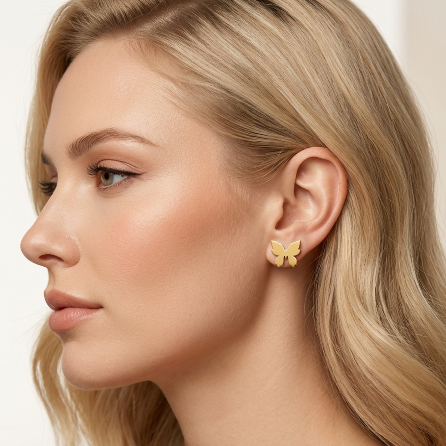 ZARIVA Astera Mini Star Stud Earrings displayed on a stone surface. Premium SS316L stainless steel earrings with 18K PVD gold plating, anti-tarnish finish and lightweight open star design.